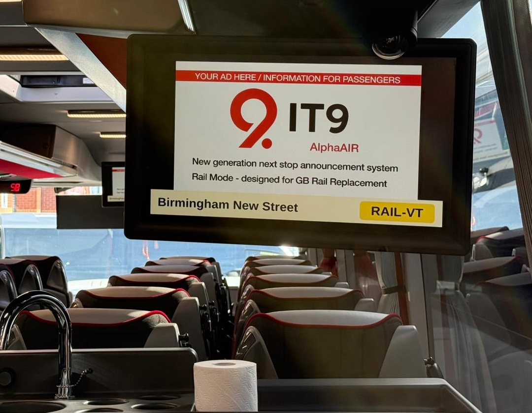 The Alpha AIR screen branded for IT9, running rail-replacement mode into Birmingham New Street with a RAIL-VT badge.